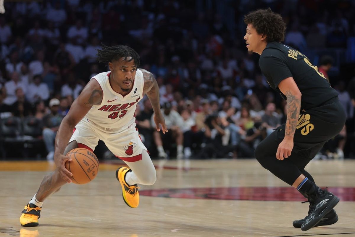 Apr 28, 2025; Miami, Florida, USA; Miami Heat guard Davion Mitchell (45) drives to the basket against Cleveland Cavaliers guard Craig Porter Jr. (9) in the fourth quarter during game four for the first round of the 2025 NBA Playoffs at Kaseya Center. Mandatory Credit: Sam Navarro-Imagn Images