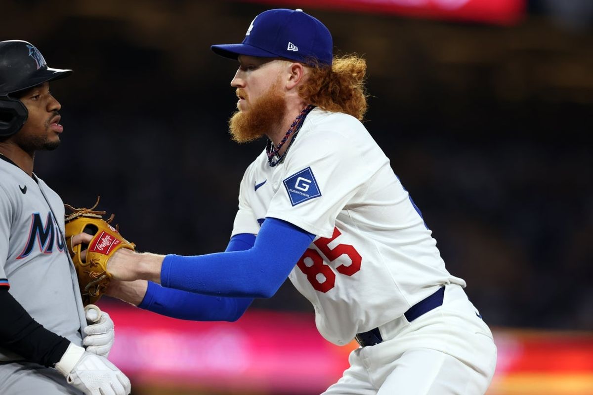 Apr 28, 2025; Los Angeles, California, USA; Los Angeles Dodgers pitcher Dustin May (85) tags out Miami Marlins shortstop Xavier Edwards (9) during the third inning at Dodger Stadium. Mandatory Credit: Jason Parkhurst-Imagn Images