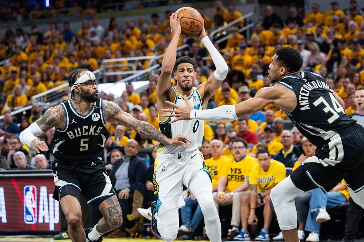 Apr 29, 2025; Indianapolis, Indiana, USA; Indiana Pacers guard Tyrese Haliburton (0) shoots the ball while Milwaukee Bucks guard Gary Trent Jr. (5) and  forward Giannis Antetokounmpo (34) defend during game five of the first round for the 2024 NBA Playoffs at Gainbridge Fieldhouse. Mandatory Credit: Trevor Ruszkowski-Imagn Images