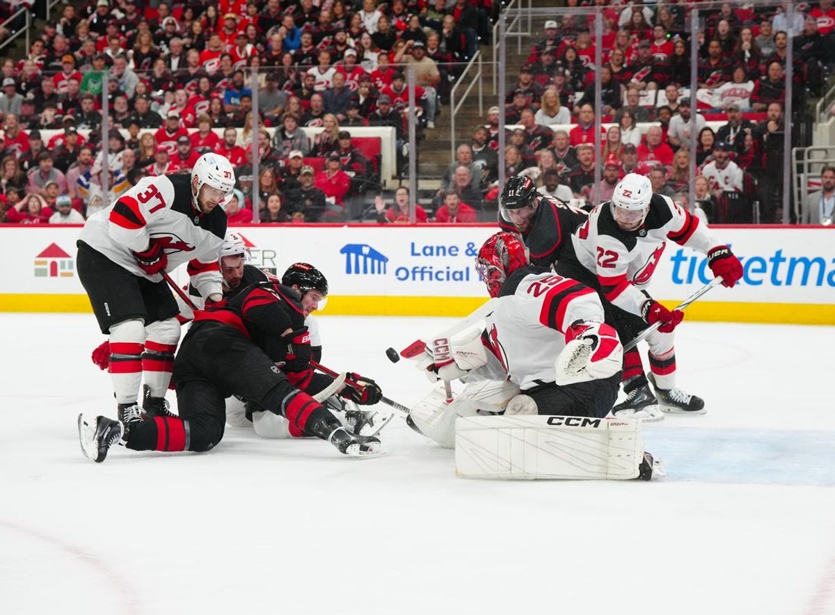 Apr 29, 2025; Raleigh, North Carolina, USA; New Jersey Devils goaltender Jacob Markstrom (25) and center Justin Dowling (37) stops the scoring attempt buy Carolina Hurricanes right wing Andrei Svechnikov (37) during the first period in game five of the first round of the 2025 Stanley Cup Playoffs at Lenovo Center. Mandatory Credit: James Guillory-Imagn Images