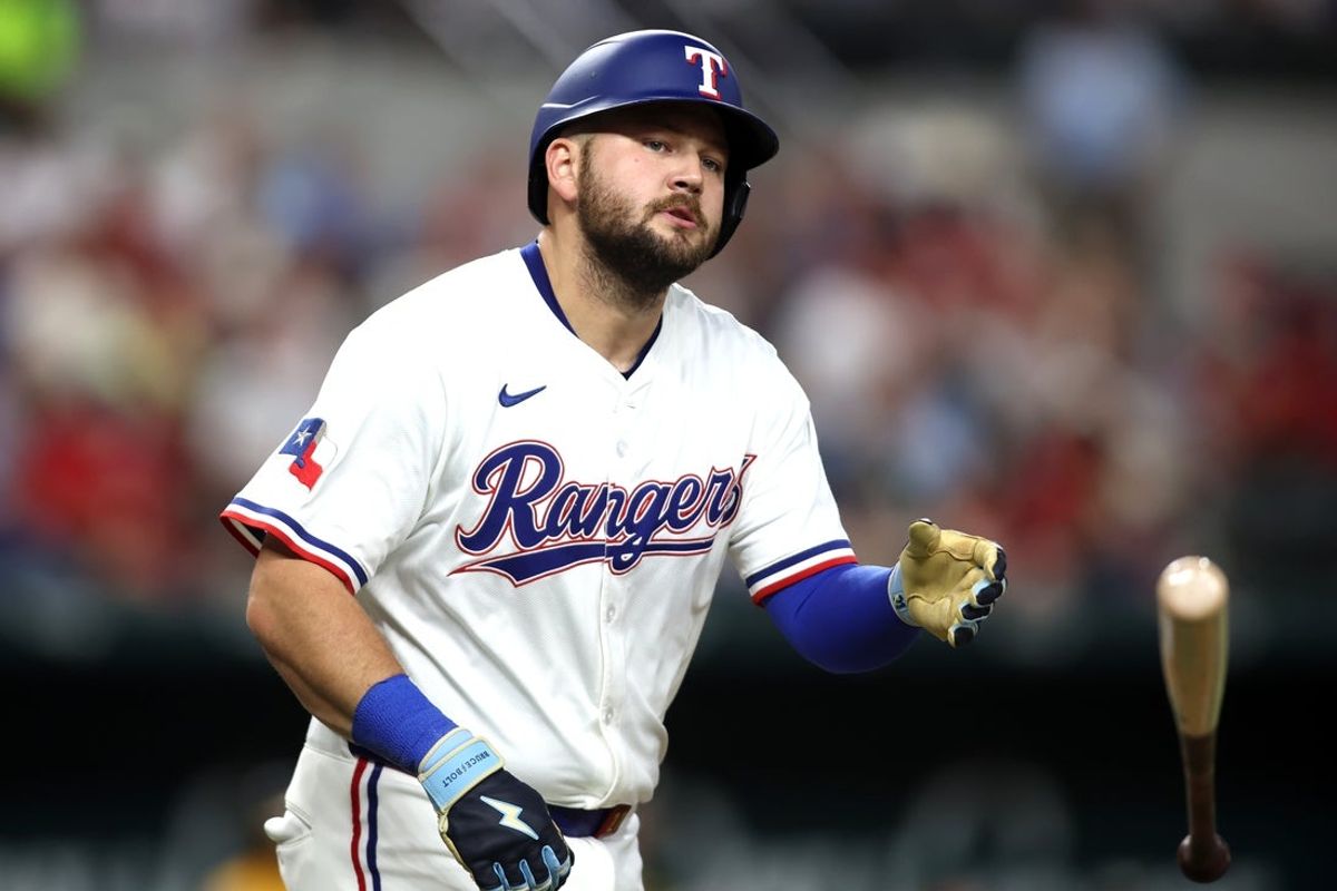 Apr 29, 2025; Arlington, Texas, USA; Texas Rangers first base Jake Burger (21) tosses his bat after being hit by a pitch during the second inning against the Oakland Athletics at Globe Life Field. Mandatory Credit: Tim Heitman-Imagn Images
