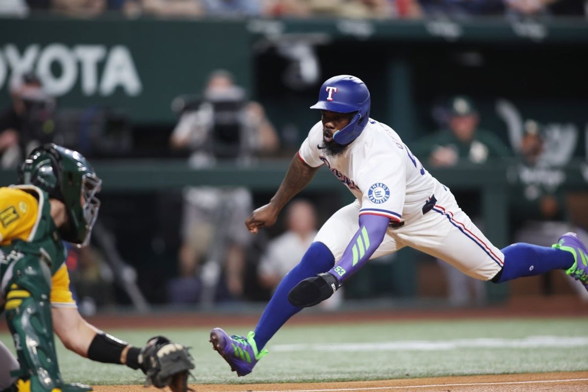 Apr 29, 2025; Arlington, Texas, USA; Texas Rangers outfielder Adolis García (53) attempts to score a run during the second inning against the Oakland Athletics at Globe Life Field. Mandatory Credit: Tim Heitman-Imagn Images