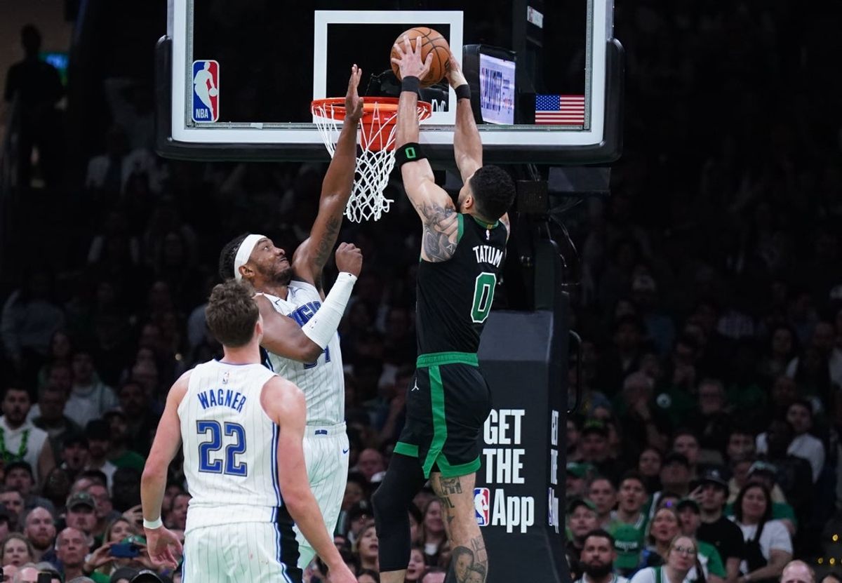Apr 29, 2025; Boston, Massachusetts, USA; Boston Celtics forward Jayson Tatum (0) makes the basket against Orlando Magic center Wendell Carter Jr. (34) in the last seconds of the second quarter during game five of first round for the 2025 NBA Playoffs at TD Garden. Mandatory Credit: David Butler II-Imagn Images