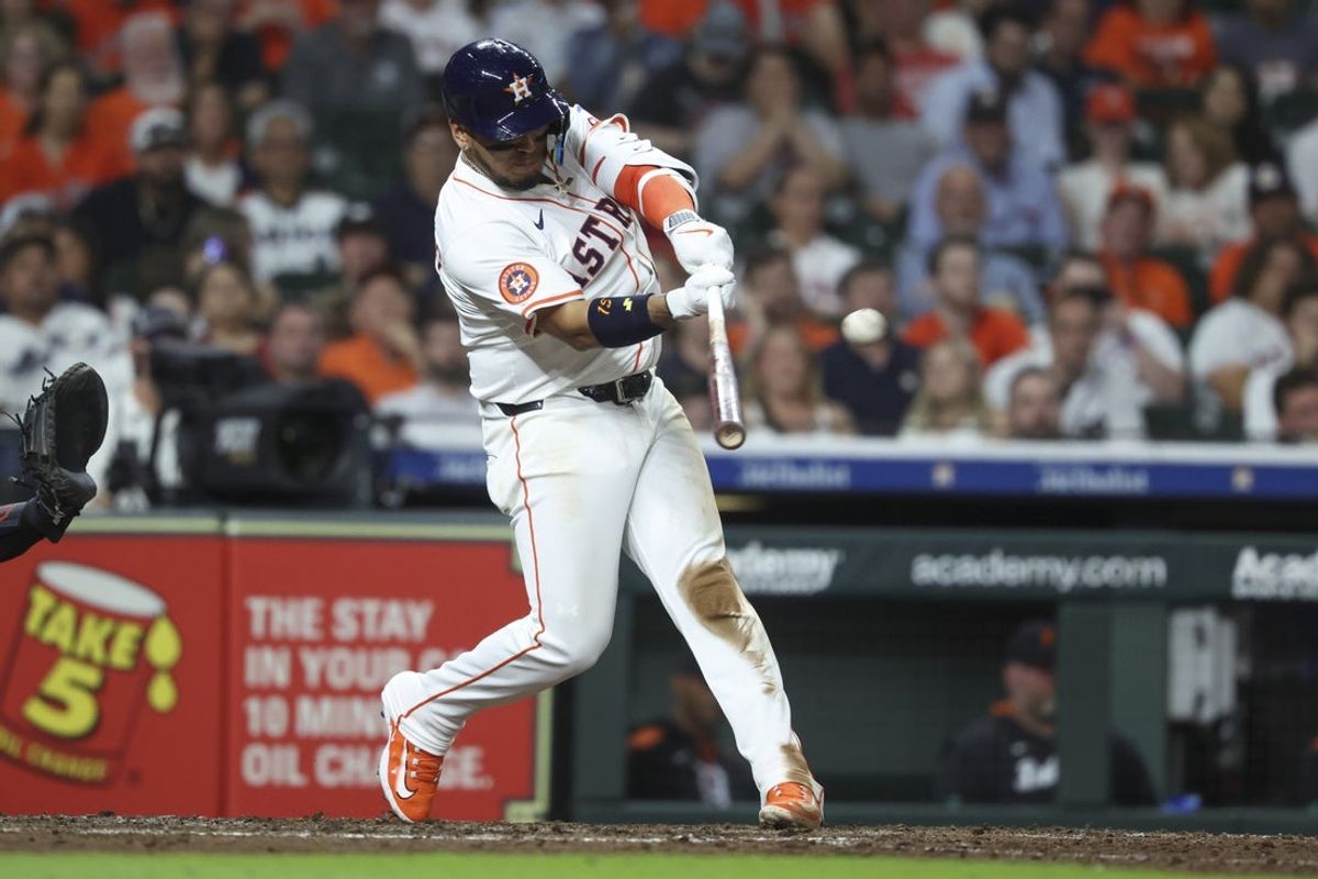 Apr 29, 2025; Houston, Texas, USA; Houston Astros third baseman Isaac Paredes (15) hits an RBI triple during the seventh inning against the Detroit Tigers at Daikin Park. Mandatory Credit: Troy Taormina-Imagn Images