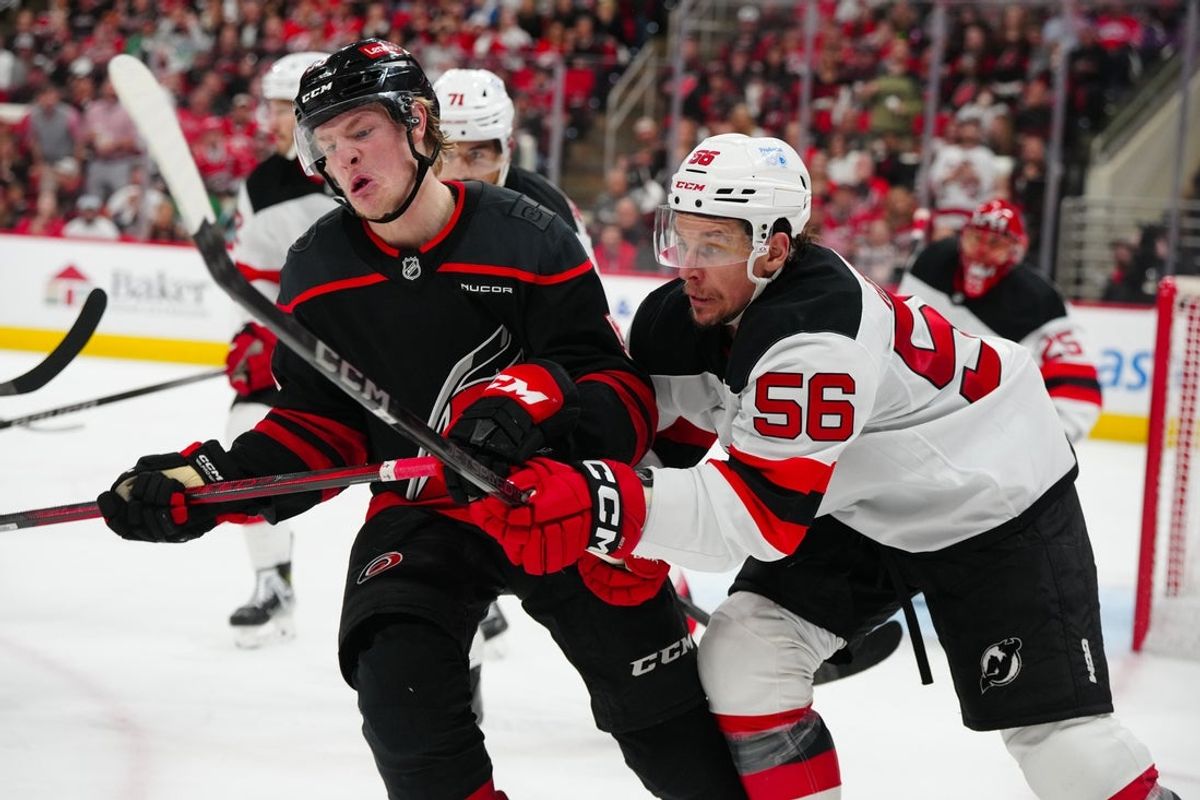 Apr 29, 2025; Raleigh, North Carolina, USA; Carolina Hurricanes right wing Jackson Blake (53) and New Jersey Devils left wing Erik Haula (56) battle during the third period in game five of the first round of the 2025 Stanley Cup Playoffs at Lenovo Center. Mandatory Credit: James Guillory-Imagn Images