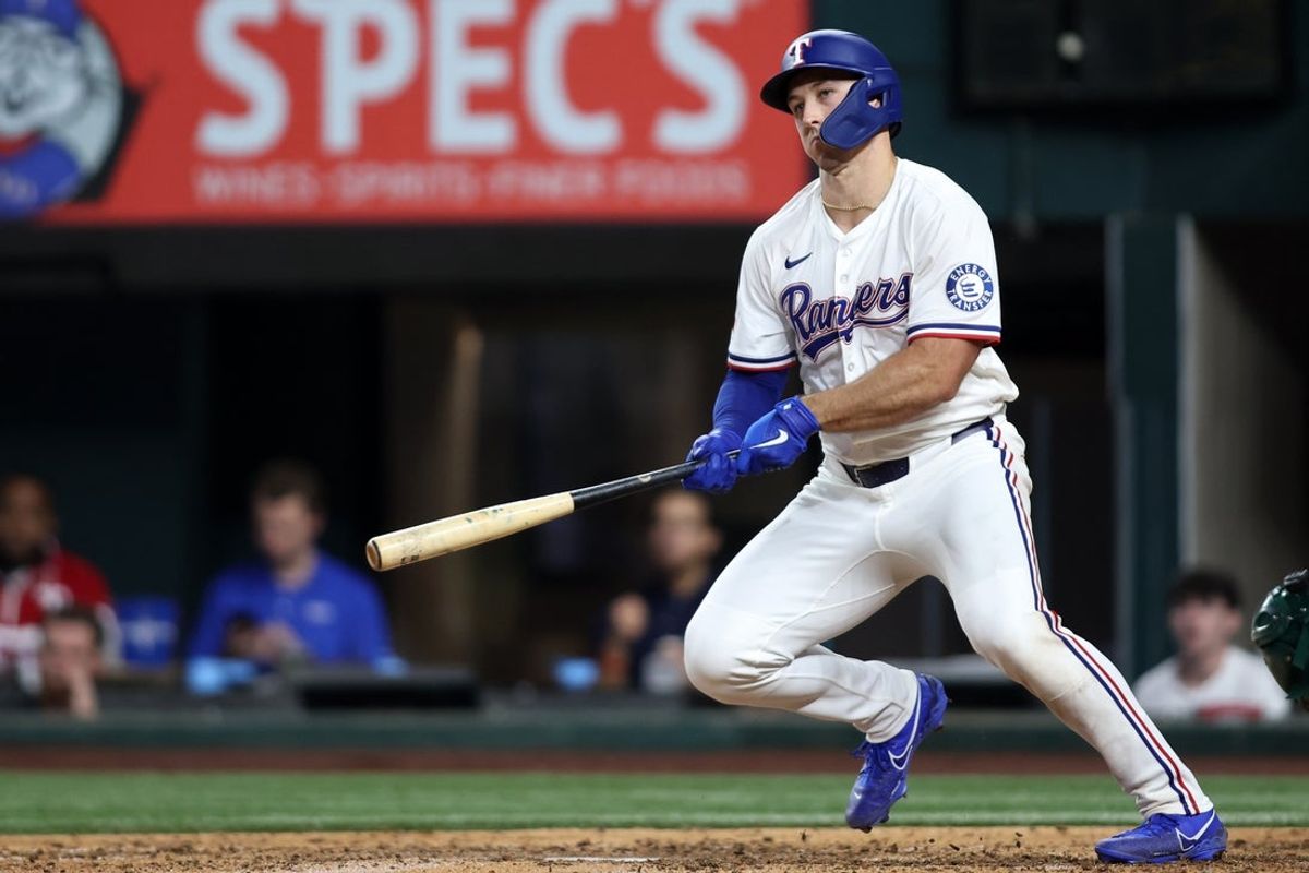 Apr 29, 2025; Arlington, Texas, USA; Texas Rangers outfielder Wyatt Langford (36) hits a three run double during the sixth inning against the Oakland Athletics at Globe Life Field. Mandatory Credit: Tim Heitman-Imagn Images