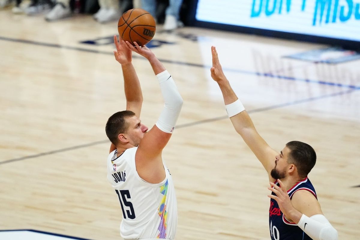 Apr 29, 2025; Denver, Colorado, USA; Denver Nuggets center Nikola Jokic (15) shoots over LA Clippers center Ivica Zubac (40) in the first quarter during five of first round for the 2025 NBA Playoffs at Ball Arena. Mandatory Credit: Ron Chenoy-Imagn Images