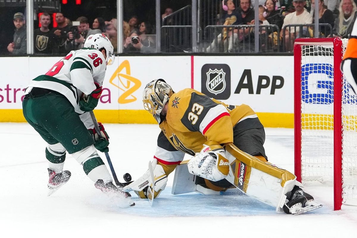 Apr 29, 2025; Las Vegas, Nevada, USA; Vegas Golden Knights goaltender Adin Hill (33) makes a save against Minnesota Wild right wing Mats Zuccarello (36) during the first period of game five of the first round of the 2025 Stanley Cup Playoffs at T-Mobile Arena. Mandatory Credit: Stephen R. Sylvanie-Imagn Images