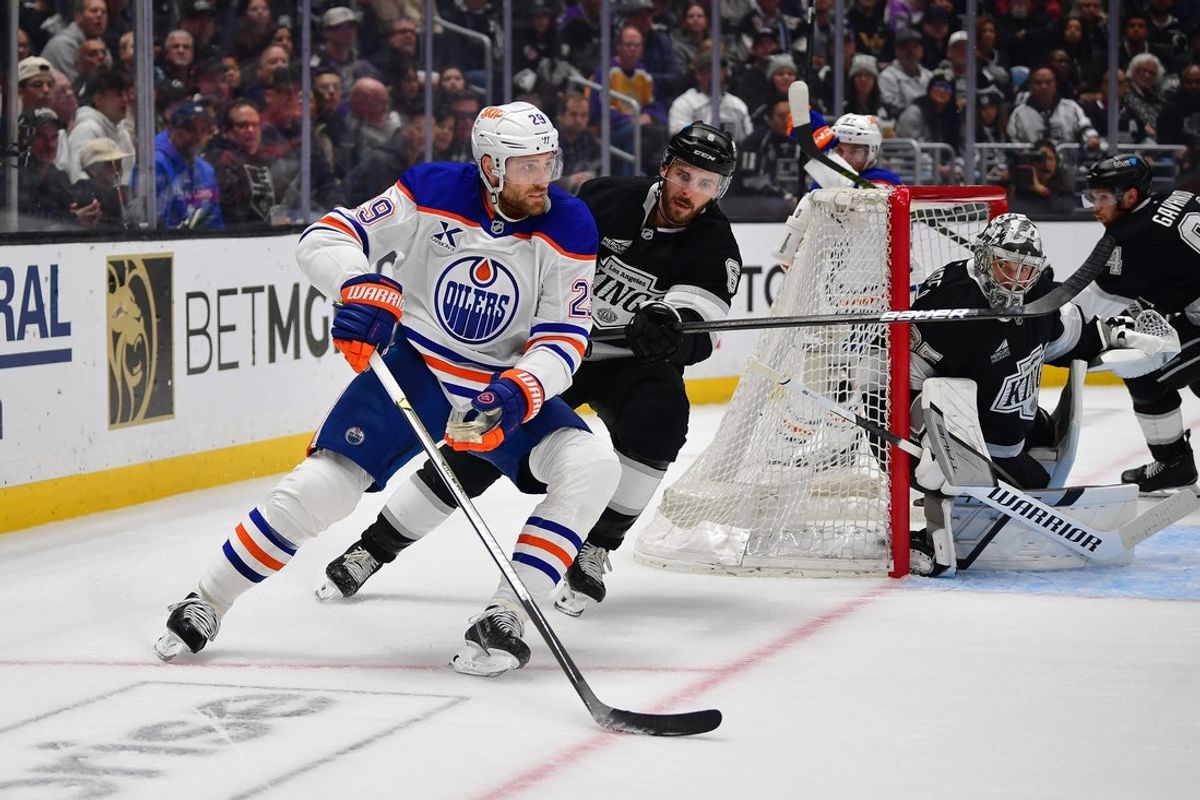 Apr 29, 2025; Los Angeles, California, USA; Edmonton Oilers center Leon Draisaitl (29) moves the puck against Los Angeles Kings defenseman Joel Edmundson (6) during the first period in game five of the first round of the 2025 Stanley Cup Playoffs at Crypto.com Arena. Mandatory Credit: Gary A. Vasquez-Imagn Images