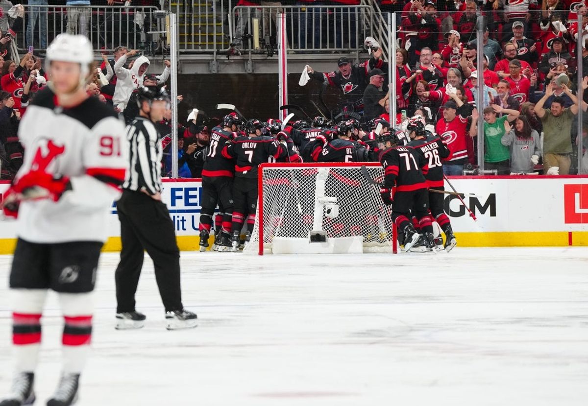 Apr 29, 2025; Raleigh, North Carolina, USA; Carolina Hurricanes center Sebastian Aho (20) scores the game winning goal in the second overtime against the New Jersey Devils in game five of the first round of the 2025 Stanley Cup Playoffs at Lenovo Center. Mandatory Credit: James Guillory-Imagn Images
