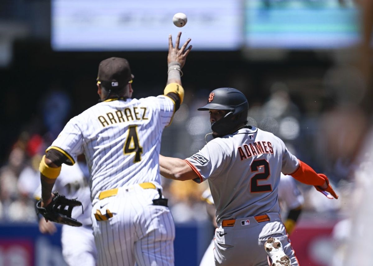 Apr 30, 2025; San Diego, California, USA; San Francisco Giants shortstop Willy Adames (2) is caught in a rundown by San Diego Padres first baseman Luis Arraez (4) during the first inning at Petco Park. Adames was out on the play. Mandatory Credit: Denis Poroy-Imagn Images
