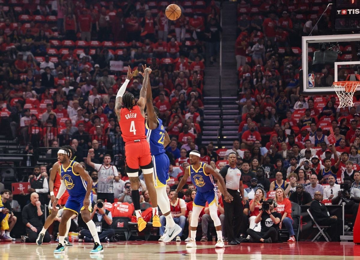 Apr 30, 2025; Houston, Texas, USA; Houston Rockets guard Jalen Green (4) makes a three point basket against Golden State Warriors forward Draymond Green (23) in the first quarter during game five of first round for the 2025 NBA Playoffs at Toyota Center. Mandatory Credit: Thomas Shea-Imagn Images