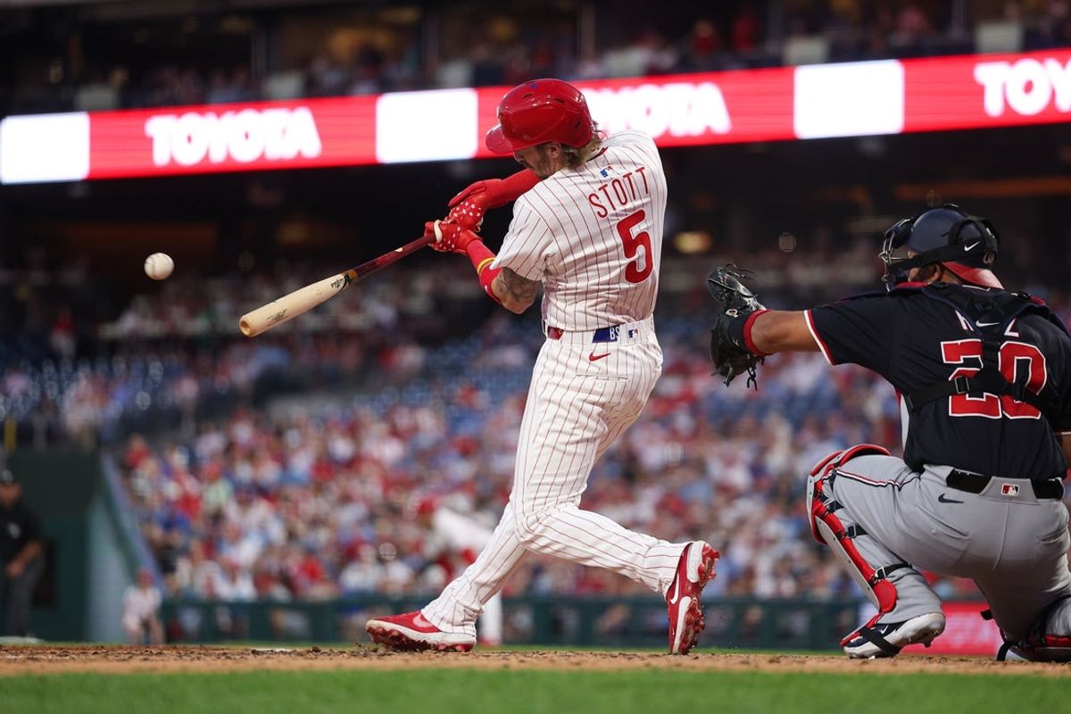 Apr 30, 2025; Philadelphia, Pennsylvania, USA; Philadelphia Phillies second base Bryson Stott (5) hits an RBI single during the fourth inning against the Washington Nationals at Citizens Bank Park. Mandatory Credit: Bill Streicher-Imagn Images