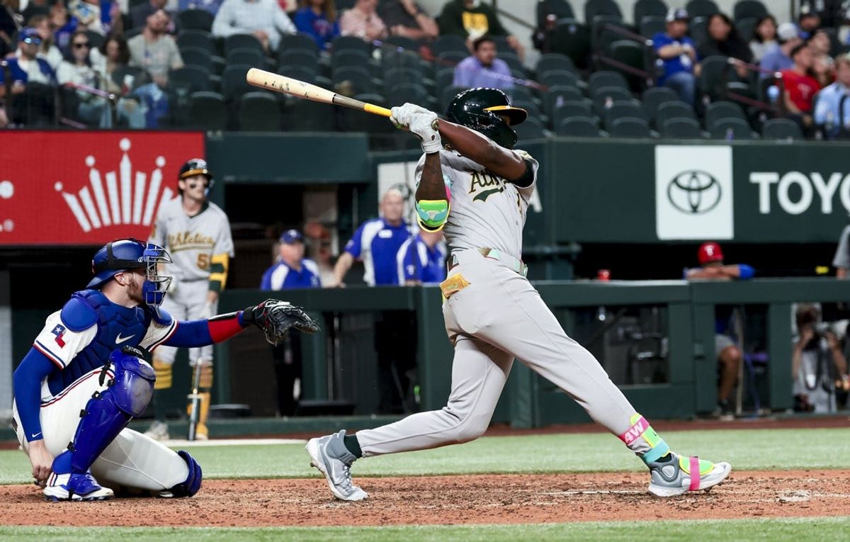 Apr 30, 2025; Arlington, Texas, USA;  Oakland Athletics right fielder Lawrence Butler (4) hits a grand slam during the ninth inning against the Texas Rangers at Globe Life Field. Mandatory Credit: Kevin Jairaj-Imagn Images