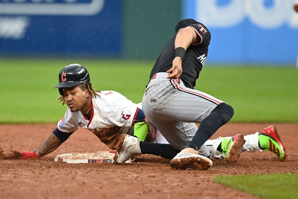 May 1, 2025; Cleveland, Ohio, USA; Cleveland Guardians designated hitter Jose Ramirez (11) steals second base during the tenth inning against the Minnesota Twins at Progressive Field. It was the 250th career stolen base for Ramirez. Mandatory Credit: Ken Blaze-Imagn Images
