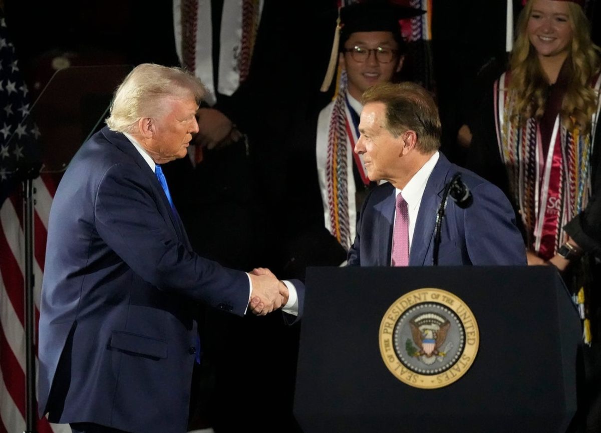 President Donald Trump shakes hands with legendary Alabama football coach Nick Saban before delivering a special commencement address to University of Alabama graduates at Coleman Coliseum on May 1, 2025. Graduation occurs over the weekend.