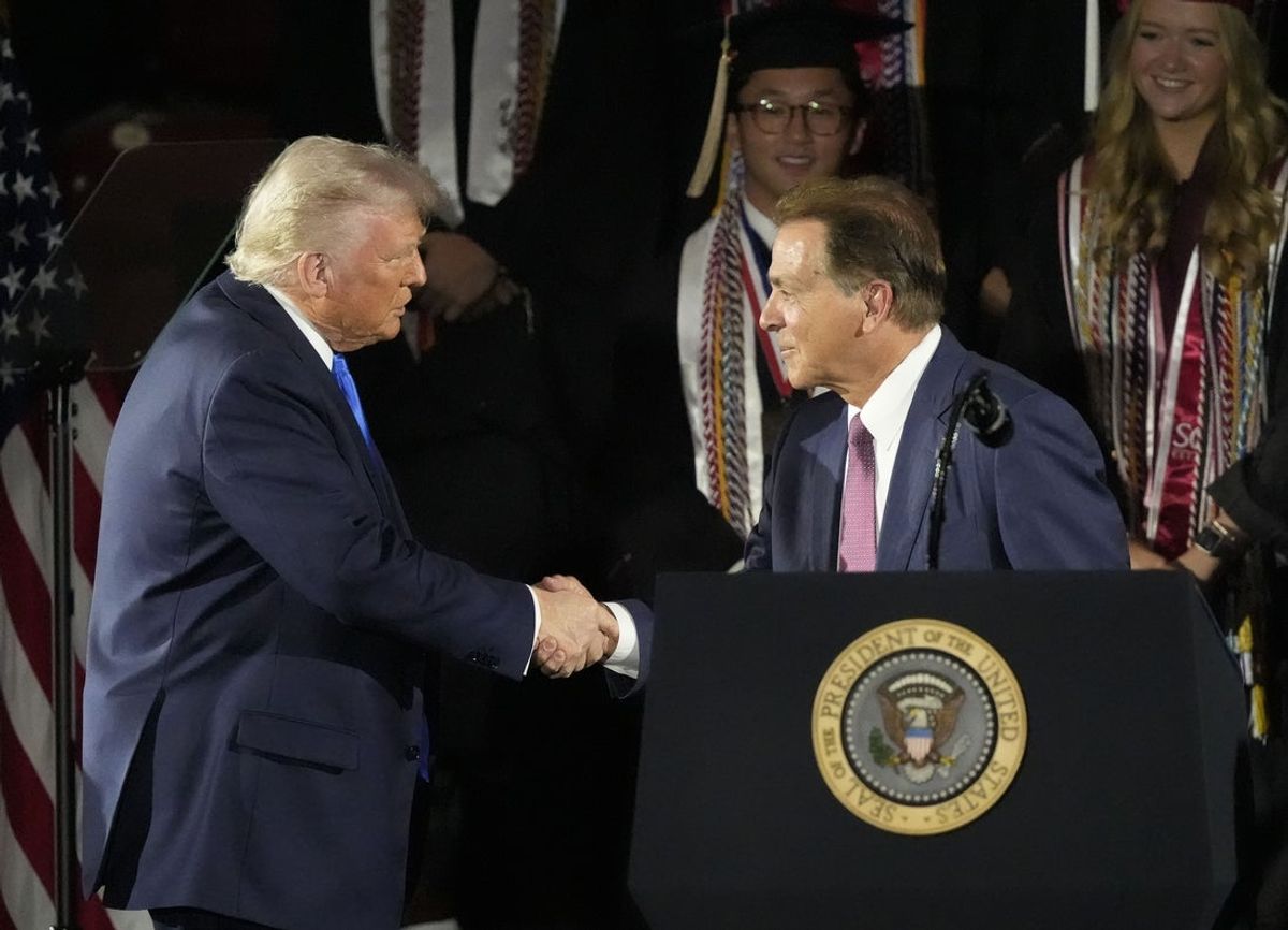 May 1, 2025; Tuscaloosa, AL, USA; President Donald Trump shakes hands with former Alabama football coach Nick Saban before delivering a special commencement address to University of Alabama graduates at Coleman Coliseum. Graduation occurs over the weekend. Mandatory Credit: Gary Cosby Jr.-Tuscaloosa News/USA Today Network via Imagn Images