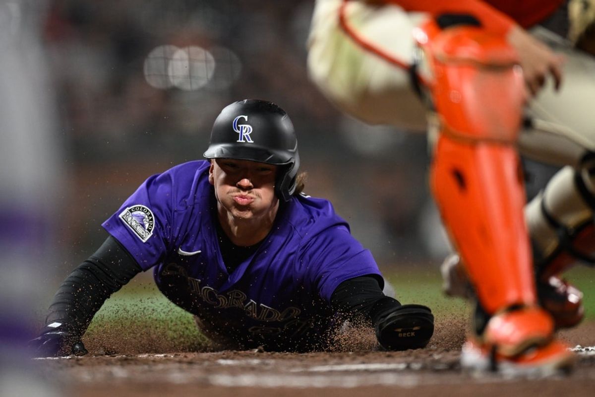 May 1, 2025; San Francisco, California, USA; Colorado Rockies left fielder Jordan Beck (27) slides home against the San Francisco Giants in the eighth inning at Oracle Park. Mandatory Credit: Eakin Howard-Imagn Images