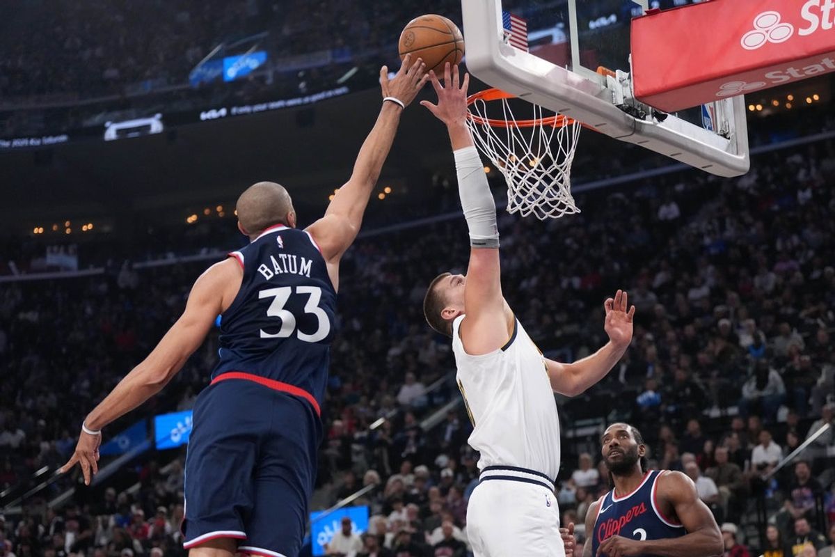 May 1, 2025; Inglewood, California, USA; LA Clippers forward Nicolas Batum (33) blocks a shot by Denver Nuggets center Nikola Jokic (15) in the first half during game six of first round for the 2025 NBA Playoffs at Intuit Dome. Mandatory Credit: Kirby Lee-Imagn Images