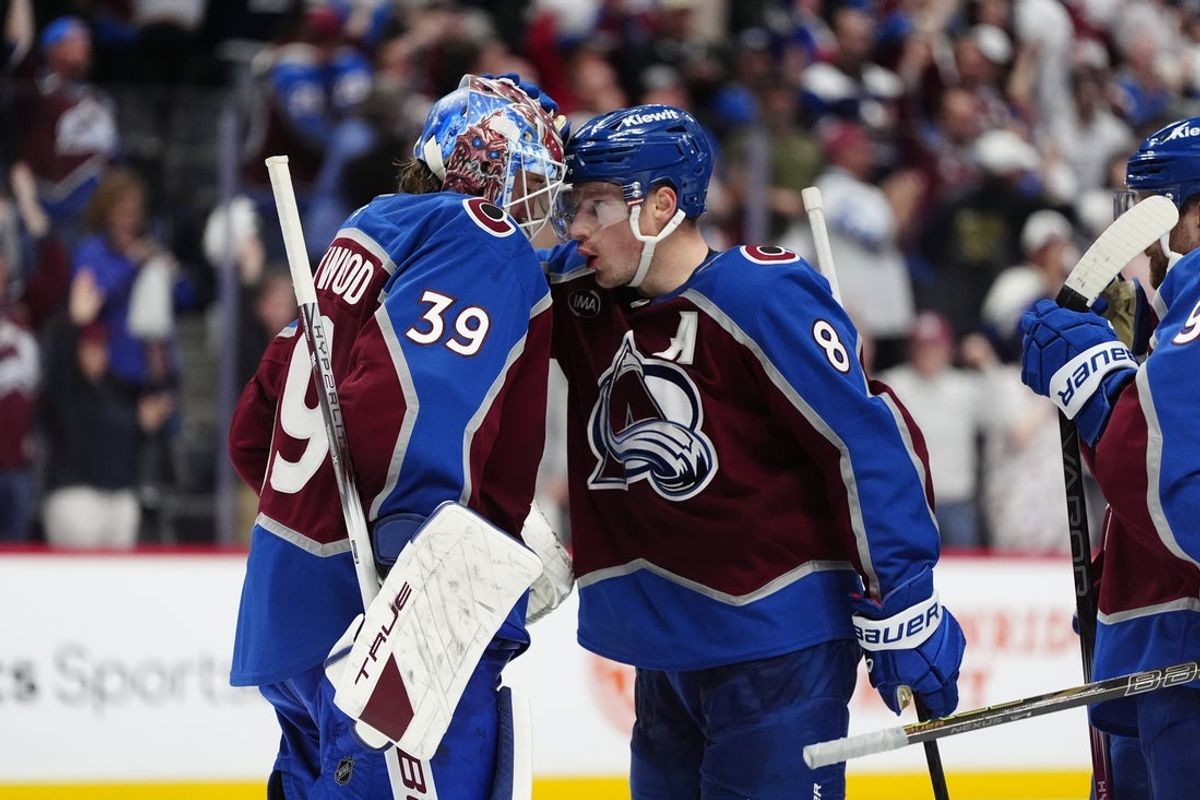 May 1, 2025; Denver, Colorado, USA; Colorado Avalanche goaltender Mackenzie Blackwood (39) and defenseman Cale Makar (8) celebrate defeating the Dallas Stars in game six of the first round of the 2025 Stanley Cup Playoffs at Ball Arena. Mandatory Credit: Ron Chenoy-Imagn Images