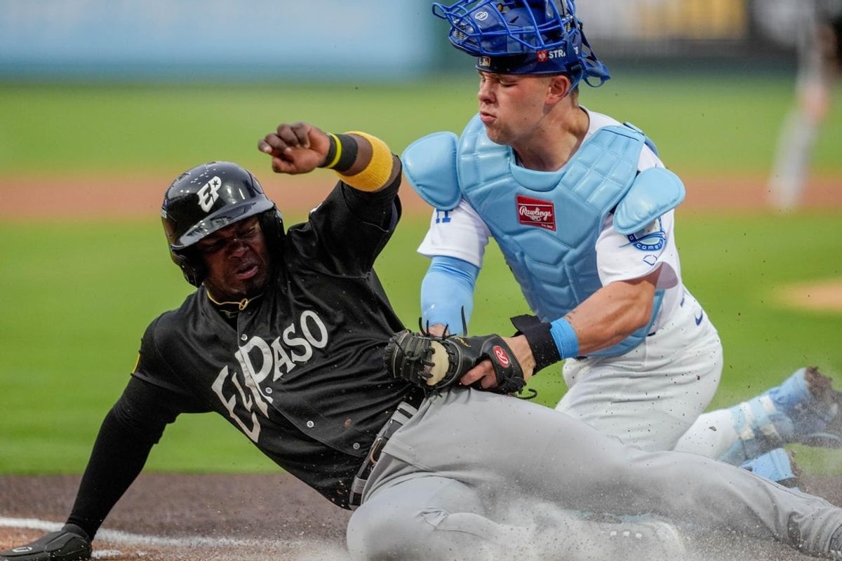 El Paso infielder Yonathan Perlaza (5) attempts to steal home and is tagged out by Oklahoma City catcher Dalton Rushing (21) during the home opener Minor League baseball game between the Oklahoma City Comets and the El Paso Chihuahuas at Chickasaw Bricktown Ballpark in Oklahoma City on Tuesday, April 1, 2025.