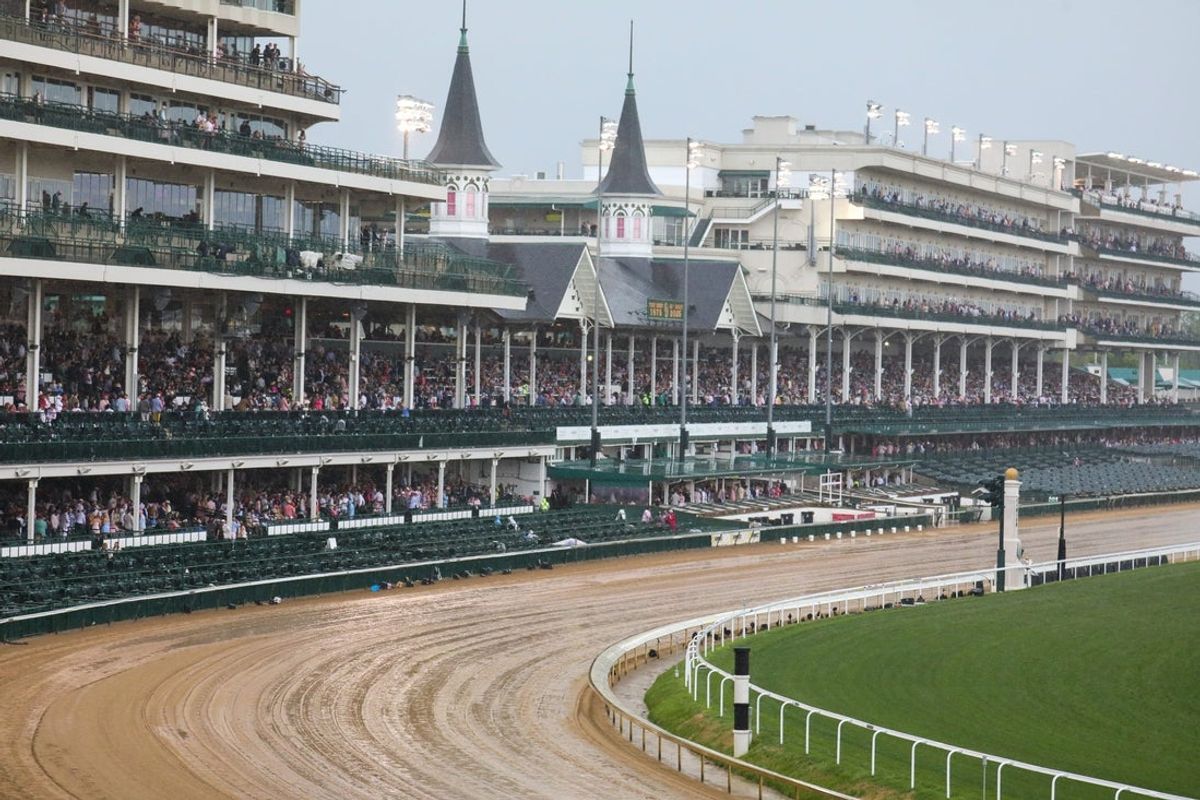 Trackgoers deal with rain, at Churchill Downs on Oaks Day, one day before the 151th running of The Kentucky Derby. Friday, May 2, 2025