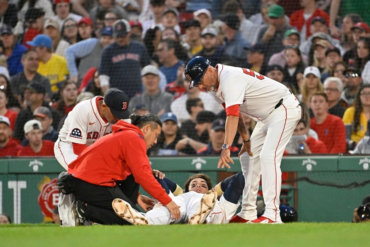 May 2, 2025; Boston, Massachusetts, USA; Boston Red Sox first baseman Triston Casas (36) is attended to by coaching and medical staff during the second inning against the Minnesota Twins at Fenway Park. Mandatory Credit: Eric Canha-Imagn Images