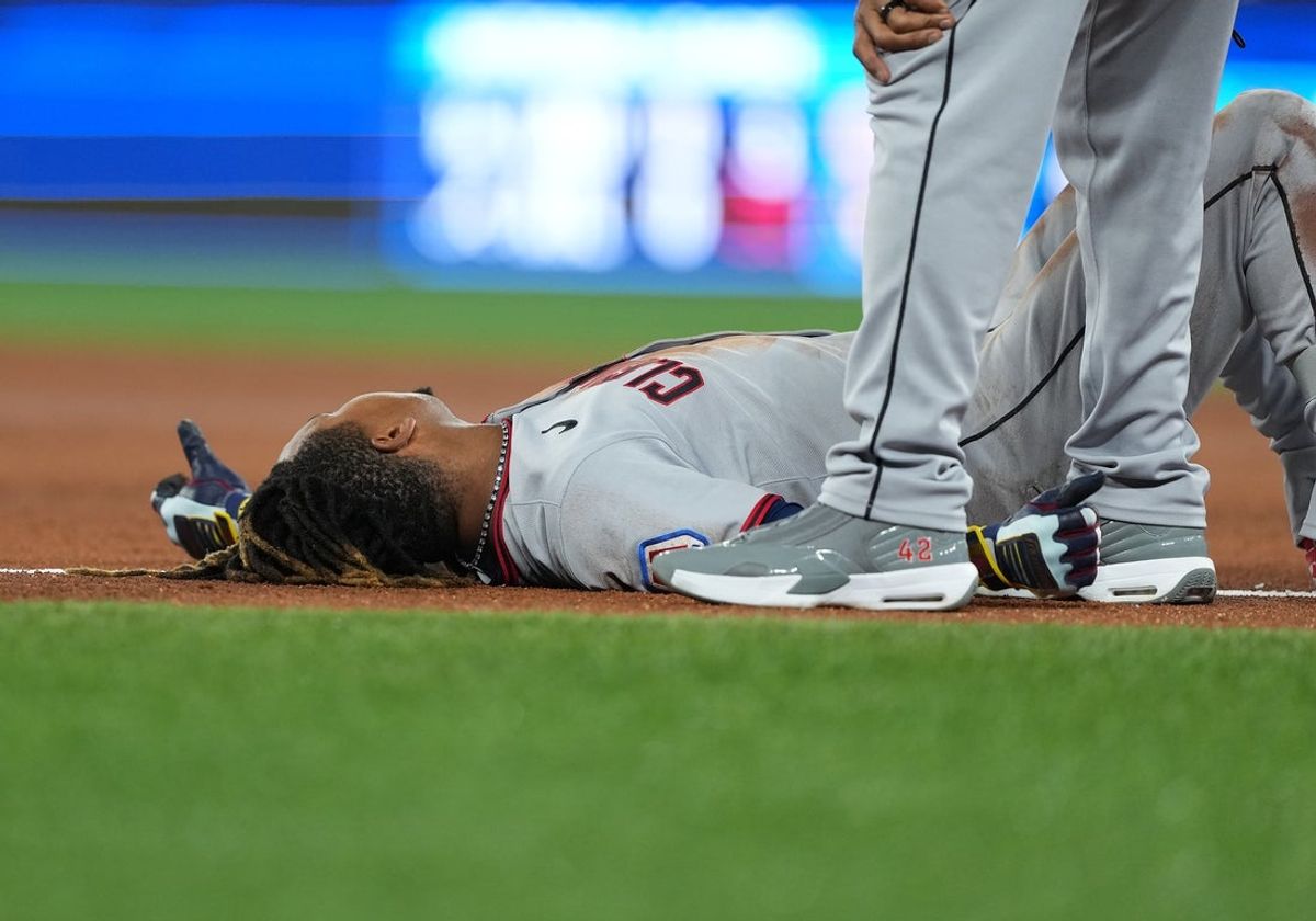 May 2, 2025; Toronto, Ontario, CAN; Cleveland Guardians third baseman Jose Ramirez (11) lays on the infield after being hit with the ball and tripping over the first base against the Toronto Blue Jays during the third inning at Rogers Centre. Mandatory Credit: Nick Turchiaro-Imagn Images