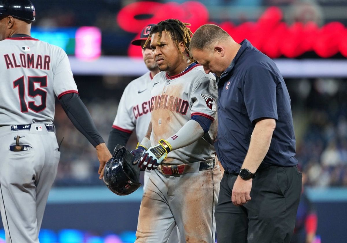 May 2, 2025; Toronto, Ontario, CAN; Cleveland Guardians third baseman Jose Ramirez (11) walks toward the dugout with a trainer after being hit with the ball and tripping over the first base against the Toronto Blue Jays during the third inning at Rogers Centre. Mandatory Credit: Nick Turchiaro-Imagn Images