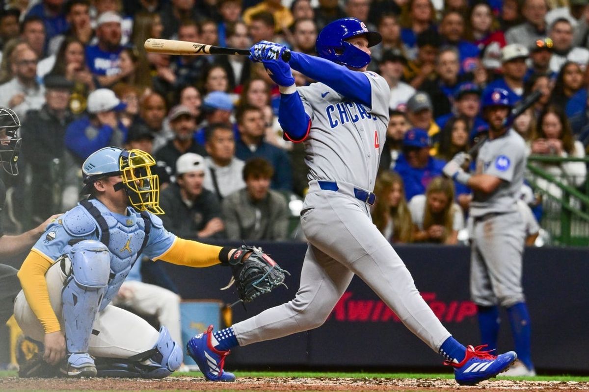 May 2, 2025; Milwaukee, Wisconsin, USA; Chicago Cubs center fielder Pete Crow-Armstrong (4) hits a solo home run in the second inning as Milwaukee Brewers catcher William Contreras (24) looks on at American Family Field. Mandatory Credit: Benny Sieu-Imagn Images