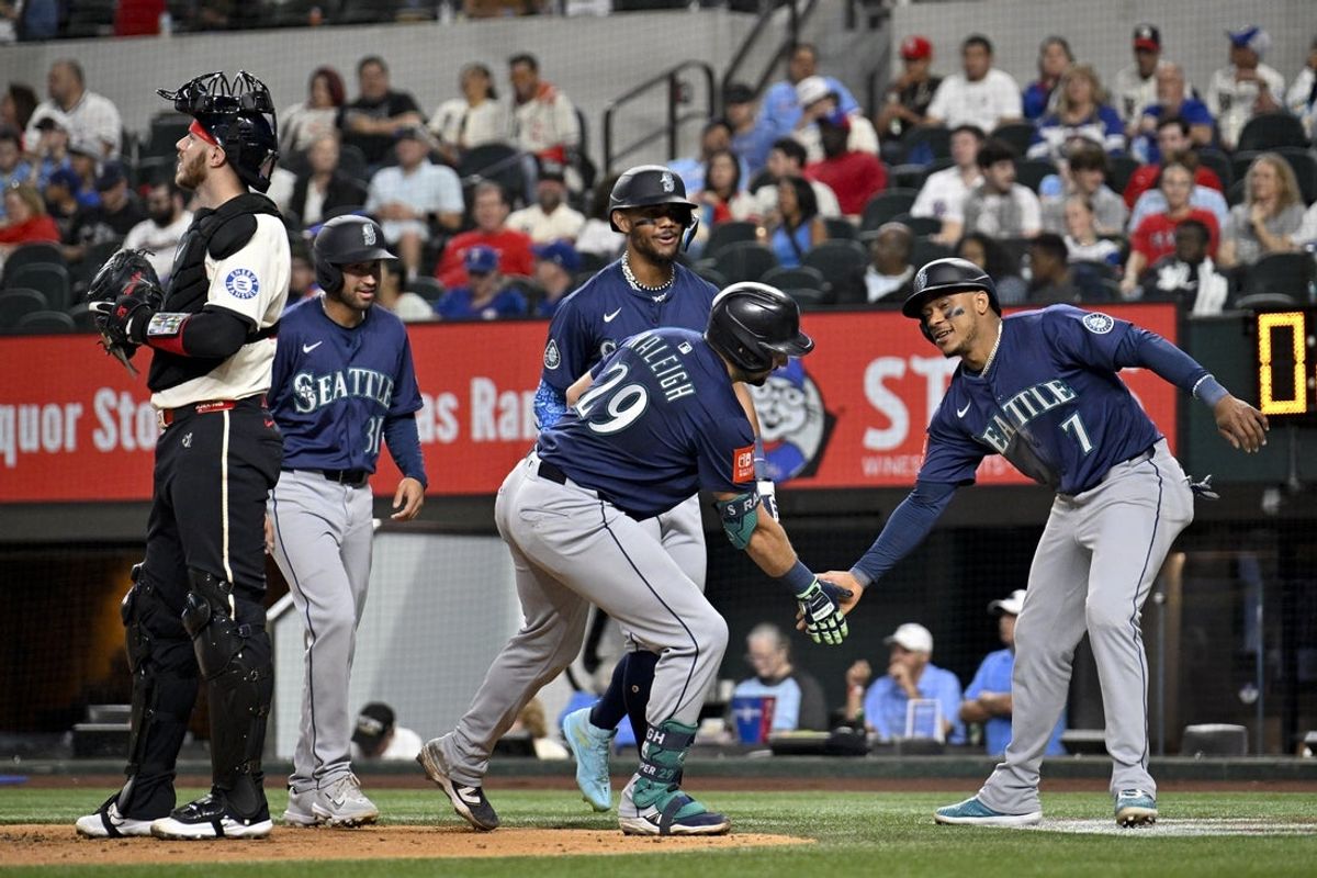 May 2, 2025; Arlington, Texas, USA; Seattle Mariners catcher Cal Raleigh (29) and designated hitter Jorge Polanco (7) and right fielder Rhylan Thomas (31) and center fielder Julio Rodriguez (44) celebrate after Raleigh hits a grand slam against the Texas Rangers during the fifth inning at Globe Life Field. Mandatory Credit: Jerome Miron-Imagn Images