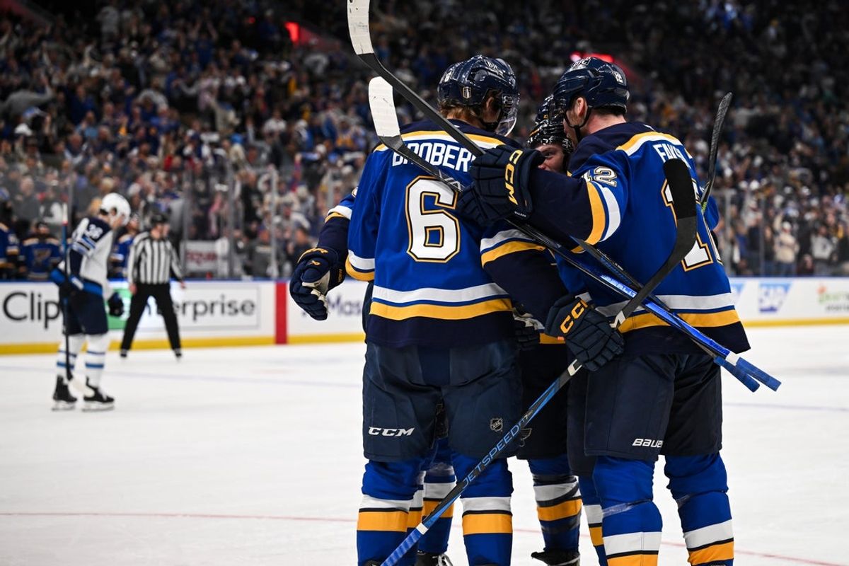 May 2, 2025; St. Louis, Missouri, USA; St. Louis Blues left wing Nathan Walker (26) celebrates with teammates after scoring a goal against the Winnipeg Jets during the second period in game six of the first round of the 2025 Stanley Cup Playoffs at Enterprise Center. Mandatory Credit: Connor Hamilton-Imagn Images