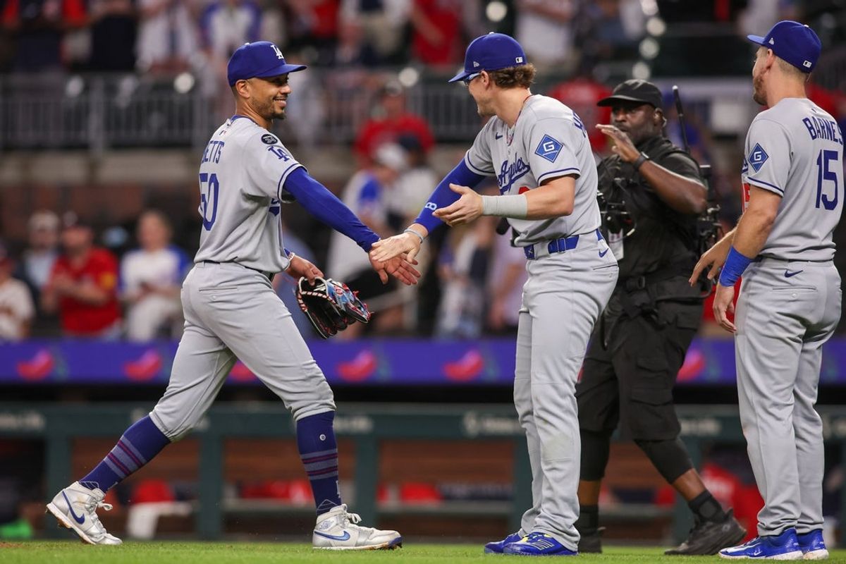 May 2, 2025; Atlanta, Georgia, USA; Los Angeles Dodgers shortstop Mookie Betts (50) and first baseman Enrique Hernandez (8) celebrate after a victory over the Atlanta Braves at Truist Park. Mandatory Credit: Brett Davis-Imagn Images