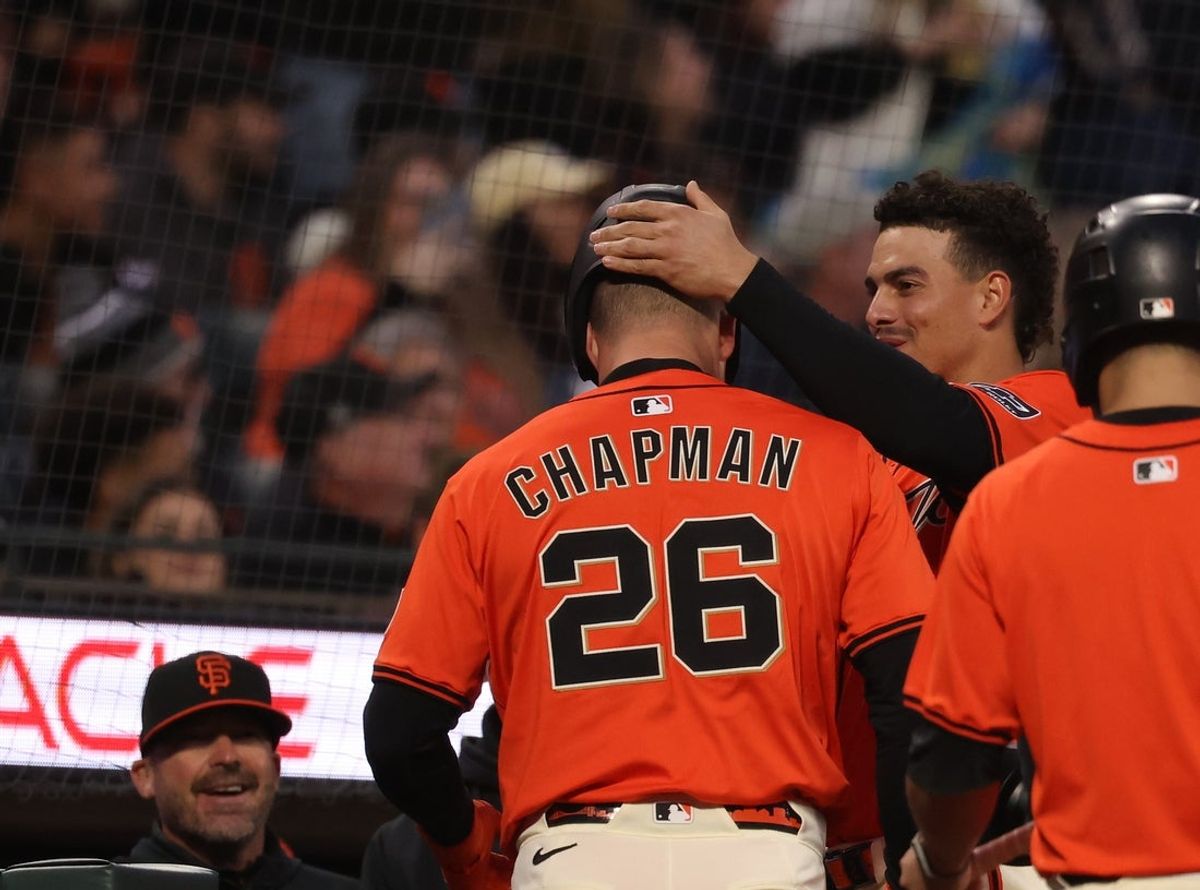 May 2, 2025; San Francisco, California, USA; San Francisco Giants shortstop Willy Adames (2) removes the helmet of third baseman Matt Chapman (26) after Chapman hit a solo home run against the Colorado Rockies during the third inning at Oracle Park. Mandatory Credit: Kelley L Cox-Imagn Images