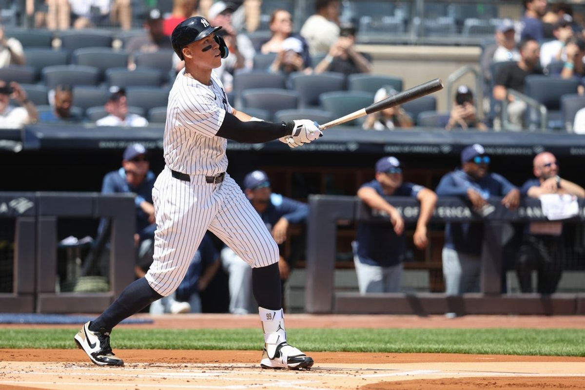 May 3, 2025; Bronx, New York, USA;  New York Yankees right fielder Aaron Judge (99) hits a solo home run in the first inning against the Tampa Bay Rays at Yankee Stadium. Mandatory Credit: Wendell Cruz-Imagn Images