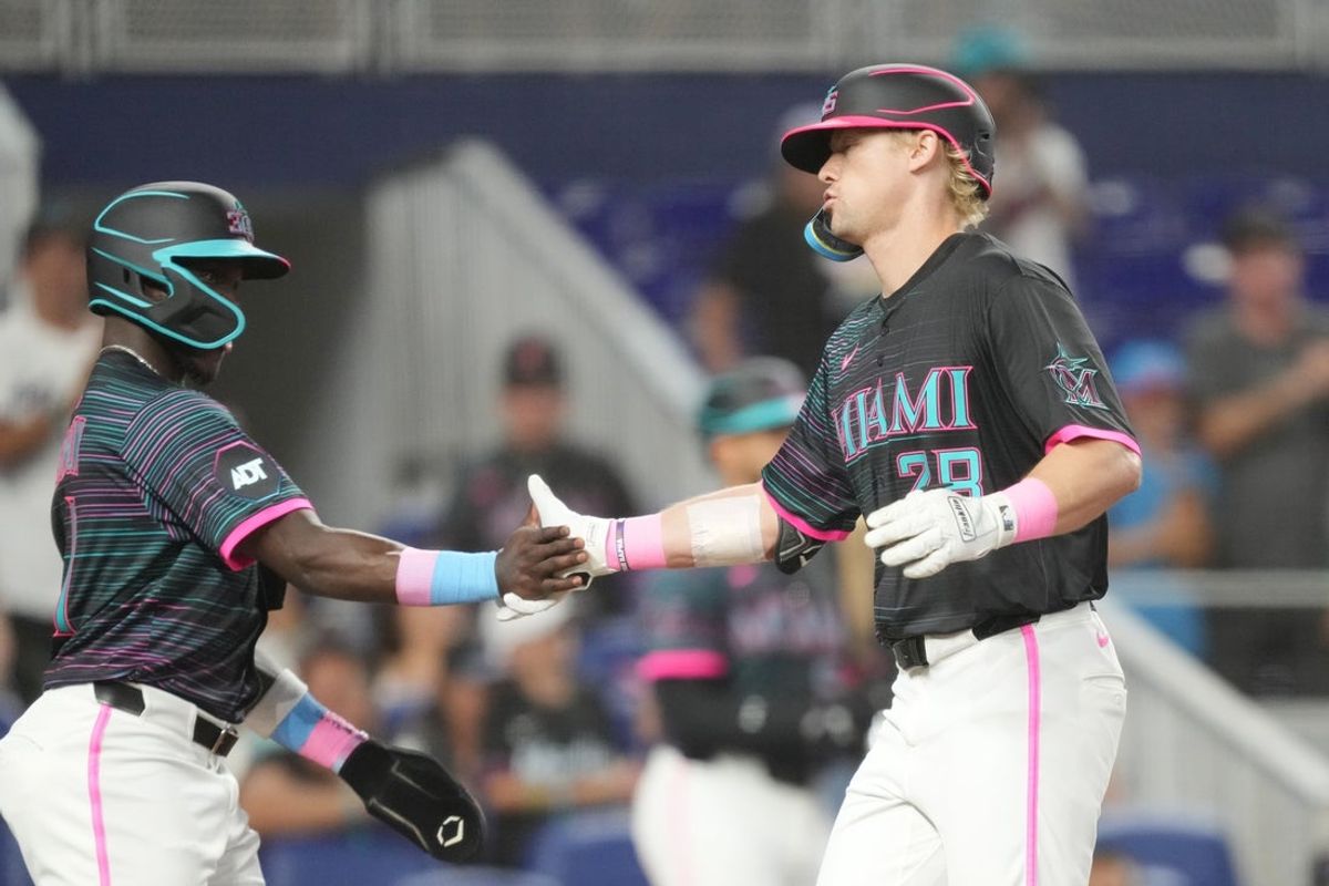 May 3, 2025; Miami, Florida, USA;  Miami Marlins right fielder Kyle Stowers (28) is congratulated by  left fielder Ronny Simon (41) following his two-run home run in the third inning against the Oakland Athletics at loanDepot Park. Mandatory Credit: Jim Rassol-Imagn Images