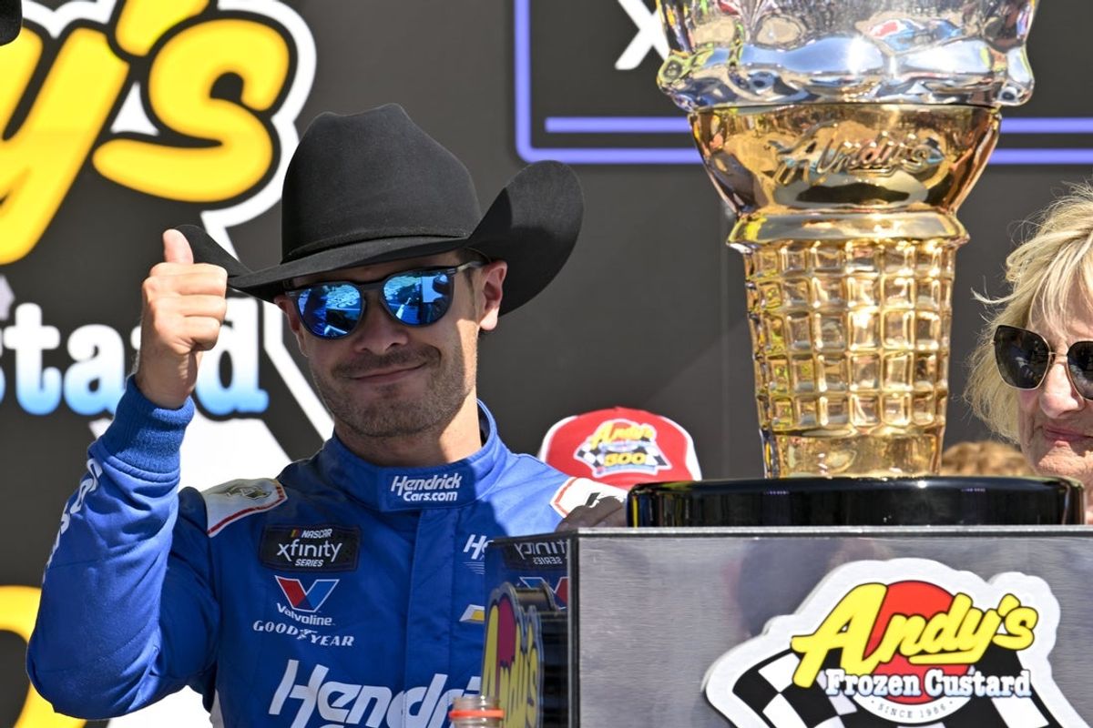 May 3, 2025; Fort Worth, Texas, USA; NASCAR Xfinity Series driver Kyle Larson (88) tries on a cowboy hat in Victory Lane after he wins the NASCAR Xfinity race at Texas Motor Speedway. Mandatory Credit: Jerome Miron-Imagn Images