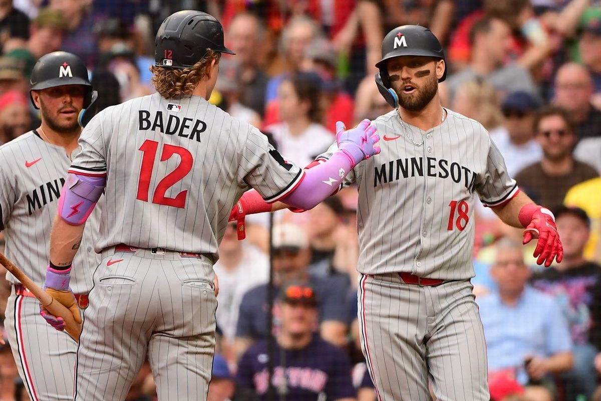 May 3, 2025; Boston, Massachusetts, USA; Minnesota Twins second baseman Kody Clemens (18) is congratulated by right fielder Harrison Bader (12) after hitting a two run home run during the sixth inning against the Boston Red Sox at Fenway Park. Mandatory Credit: Bob DeChiara-Imagn Images
