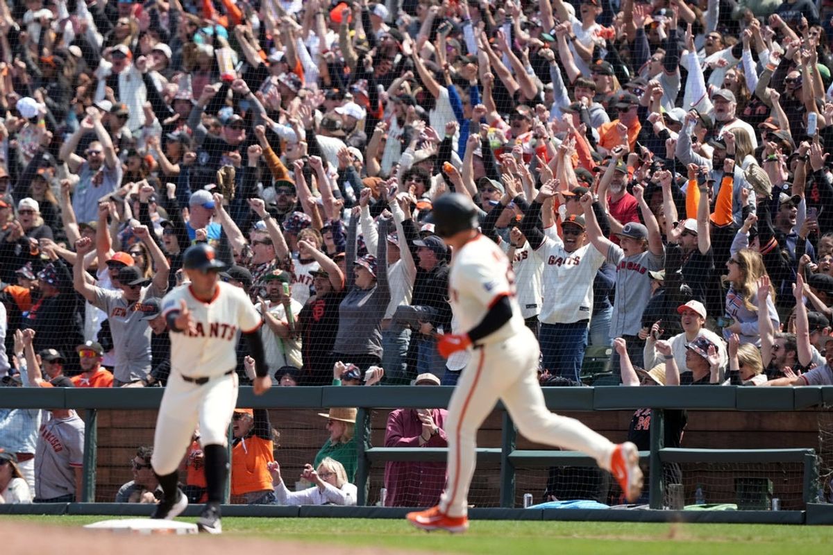 May 3, 2025; San Francisco, California, USA; San Francisco Giants fans cheer after a grand slam by third baseman Matt Chapman (foreground center) against the Colorado Rockies during the sixth inning at Oracle Park. Mandatory Credit: Darren Yamashita-Imagn Images