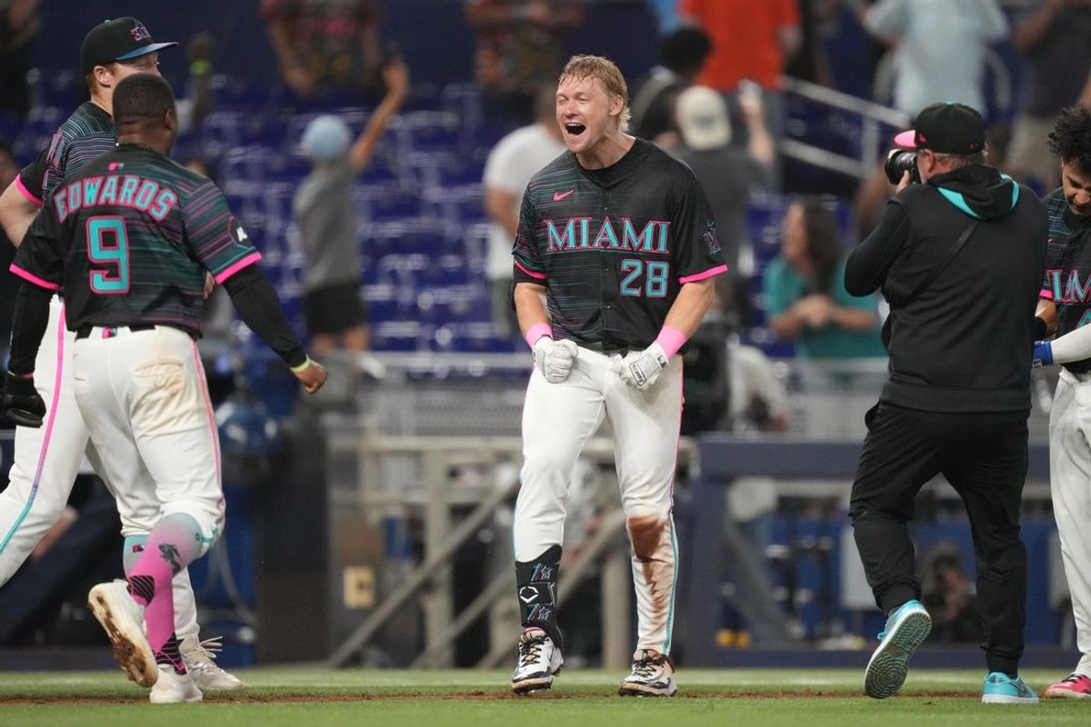 May 3, 2025; Miami, Florida, USA;  Miami Marlins right fielder Kyle Stowers (28) celebrates his walk-off grand slam against the Oakland Athletics in the ninth inning at loanDepot Park. Mandatory Credit: Jim Rassol-Imagn Images