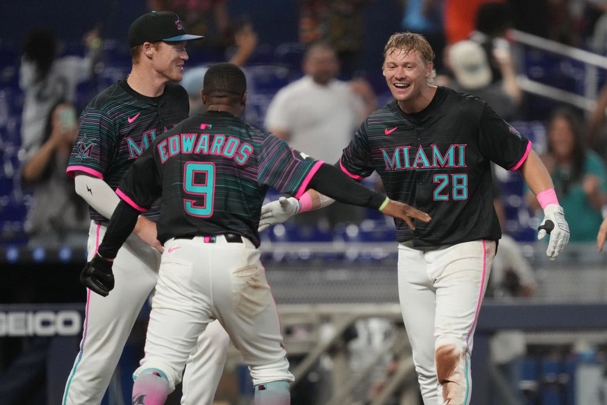 May 3, 2025; Miami, Florida, USA;  Miami Marlins right fielder Kyle Stowers (28) celebrates his walk-off grand slam in the ninth inning against the Oakland Athletics with shortstop Xavier Edwards (9) and first baseman Eric Wagaman (33) at loanDepot Park. Mandatory Credit: Jim Rassol-Imagn Images