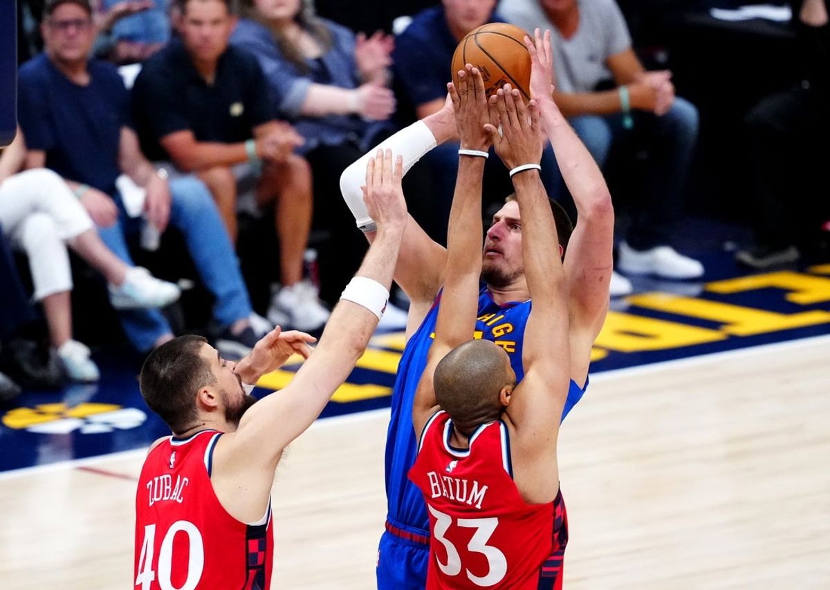 May 3, 2025; Denver, Colorado, USA; LA Clippers center Ivica Zubac (40) and forward Nicolas Batum (33) defend on Denver Nuggets center Nikola Jokic (15) in the first half during game seven of first round for the 2025 NBA Playoffs at Ball Arena. Mandatory Credit: Ron Chenoy-Imagn Images