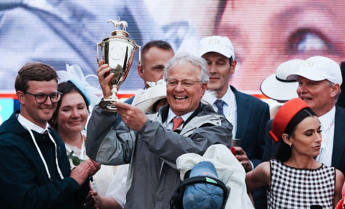 Trainer Bill Mott celebrated with the trophy in the winner's circle after jockey Junior Alvarado rode Sovereignty to victory during the Kentucky Derby at Churchill Downs in Louisville, Ky. on May 3, 2025.