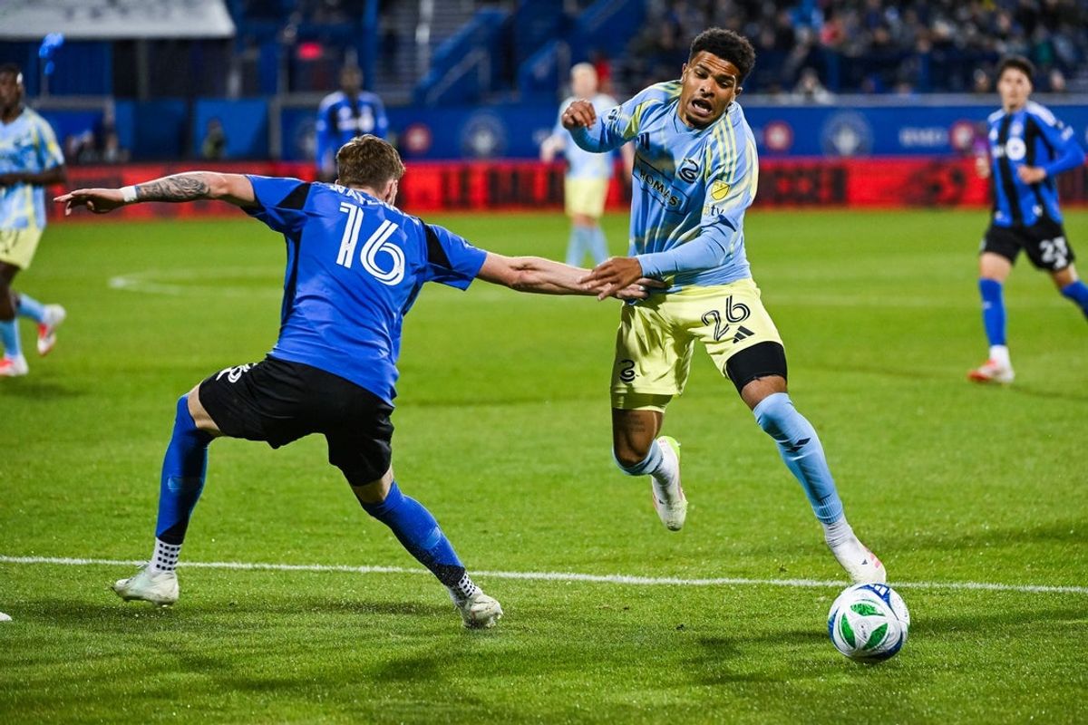 May 3, 2025; Montreal, Province of Quebec, CAN; Philadelphia Union defender Nathan Harriel (26) plays the ball against CF Montreal defender Joel Waterman (16) during the second half at Saputo Stadium. Mandatory Credit: David Kirouac-Imagn Images