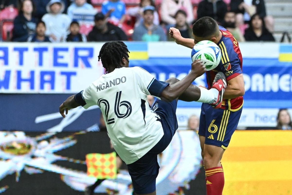 May 3, 2025; Vancouver, British Columbia, CAN;  Vancouver Whitecaps FC midfielder Jean-Claude Ngando (26) reaches for the ball against Real Salt Lake midfielder Braian Ojeda (6) during the first half at BC Place. Mandatory Credit: Simon Fearn-Imagn Images