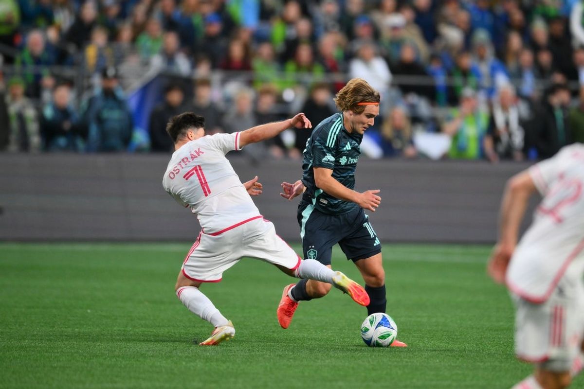May 3, 2025; Seattle, Washington, USA; Seattle Sounders FC forward Pedro De La Vega (10) advances the ball while defended by St. Louis City FC forward Tomas Ostrak (7) during the first half at Lumen Field. Mandatory Credit: Steven Bisig-Imagn Images
