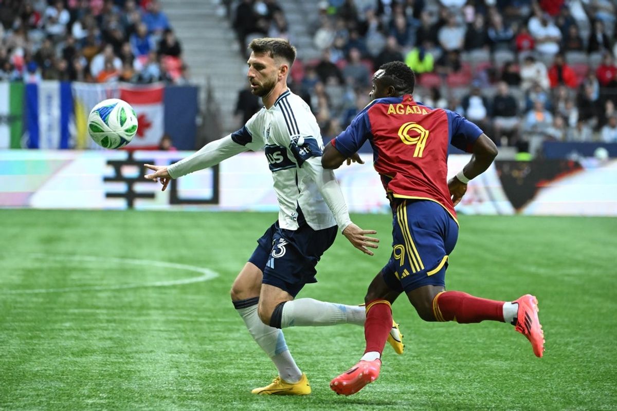 May 3, 2025; Vancouver, British Columbia, CAN;  Vancouver Whitecaps FC defender Tristan Blackmon (33) battles for the ball against Real Salt Lake foward William Agada (9) during the second half at BC Place. Mandatory Credit: Simon Fearn-Imagn Images