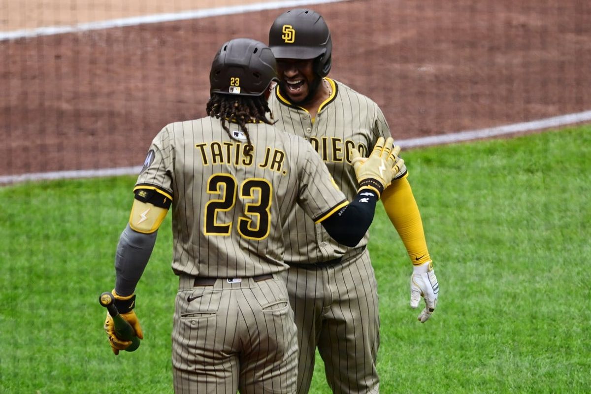May 4, 2025; Pittsburgh, Pennsylvania, USA; San Diego Padres catcher Elias Diaz (17) celebrates with right fielder Fernando Tatis Jr. (23) after hitting a solo home run off Pittsburgh Pirates starting pitcher Andrew Heaney (45) during the second inning at PNC Park. Mandatory Credit: David Dermer-Imagn Images