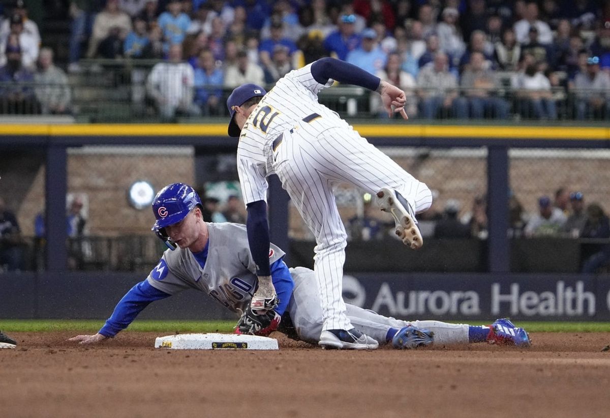 May 4, 2025; Milwaukee, Wisconsin, USA; Milwaukee Brewers second base Brice Turang (2) tags out Chicago Cubs outfielder Pete Crow-Armstrong (4) as he attempt to steal second base in the fifth inning at American Family Field. Mandatory Credit: Michael McLoone-Imagn Images