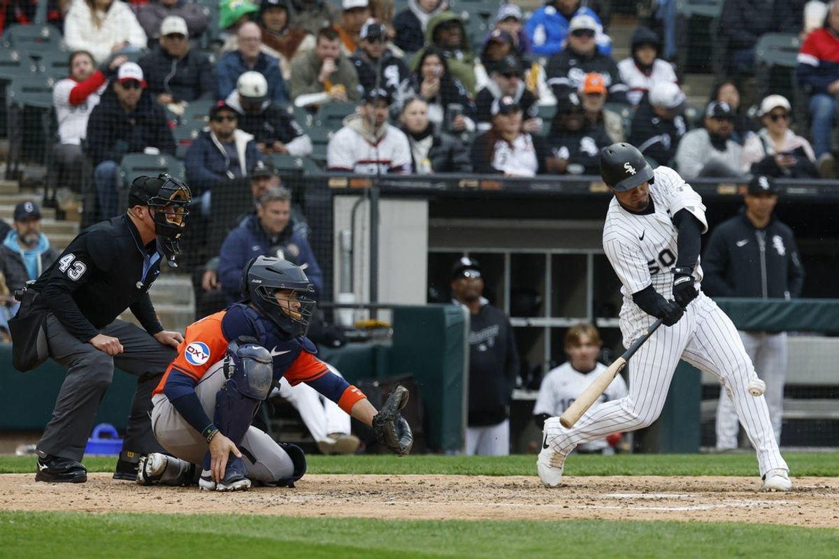 May 4, 2025; Chicago, Illinois, USA; Chicago White Sox second baseman Lenyn Sosa (50) hits a two-run single against the Houston Astros during the fifth inning at Rate Field. Mandatory Credit: Kamil Krzaczynski-Imagn Images